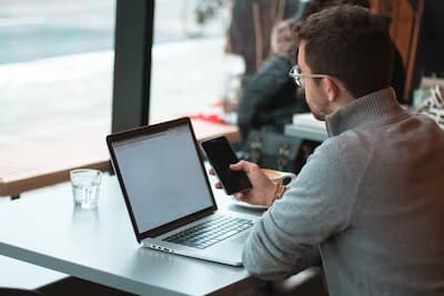 man sitting at laptop