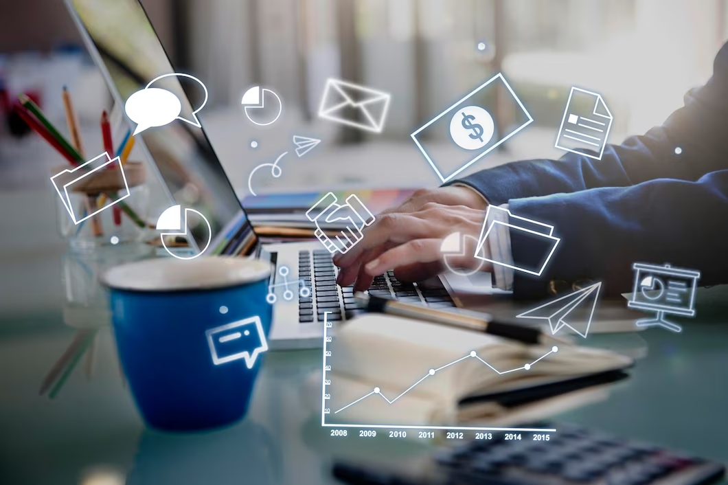 Hand typing on a laptop keyboard with a visible graphic depicting corporate management strategy and branding concept